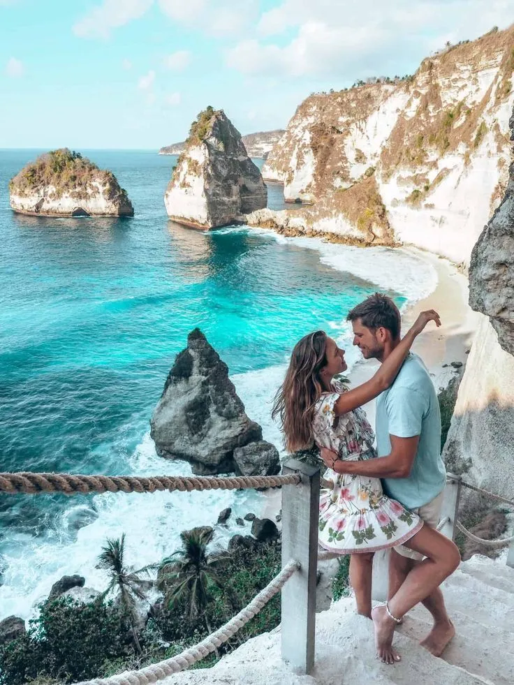 a couple standing on stairs and hugging each other