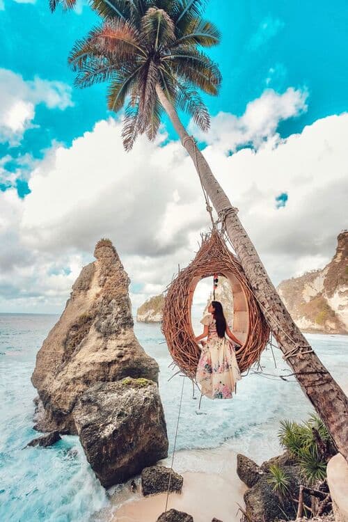 a woman sitting on a swing chair